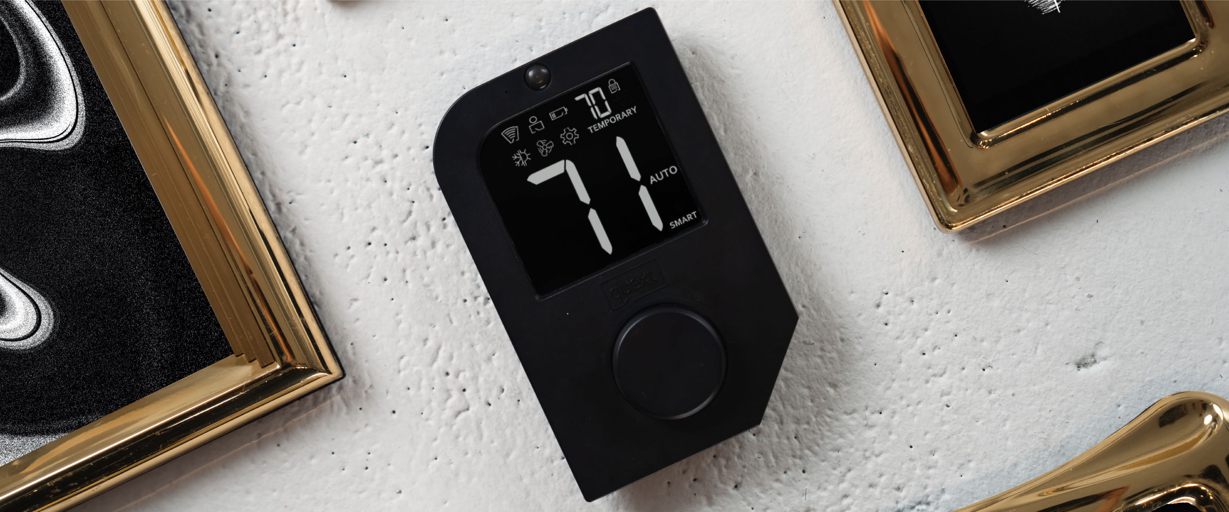 A Quext IoT thermostat on a wall