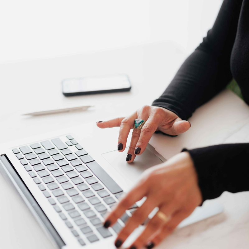 Woman typing on keyboard, connected to WiFi in her apartment